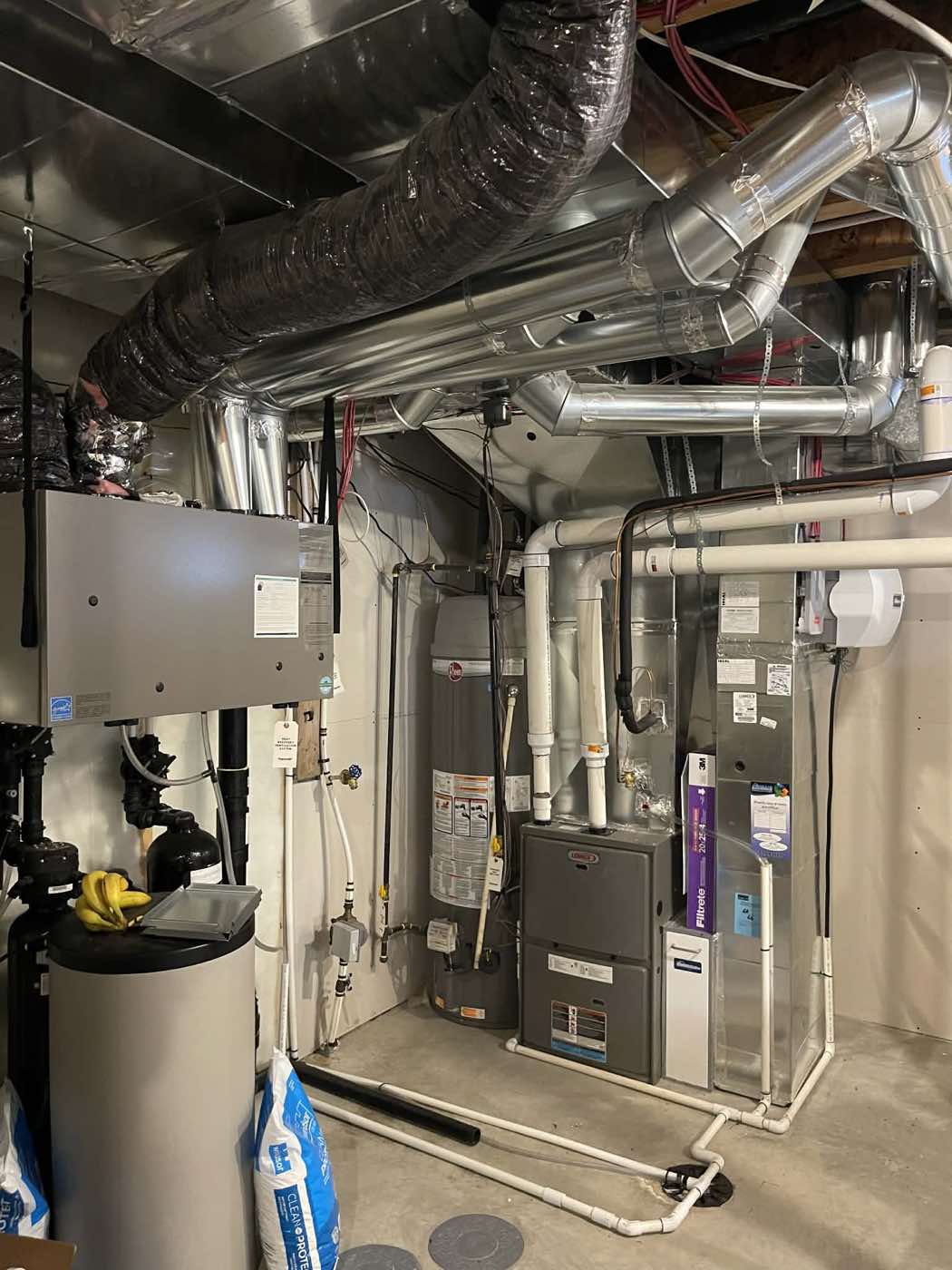 Complete mechanical room installation with furnace, water softener, and full ductwork system in a Calgary home